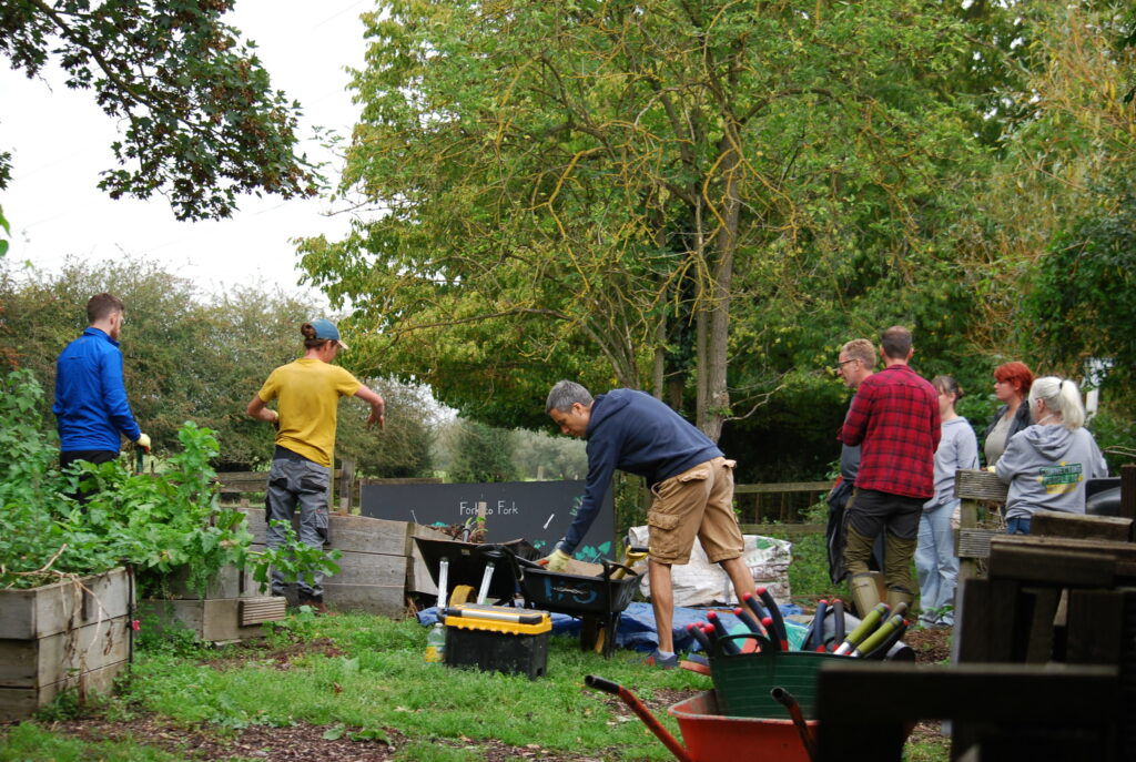 Centrica’s Responsible Business: Photo of people outside gathering gardening equipment.