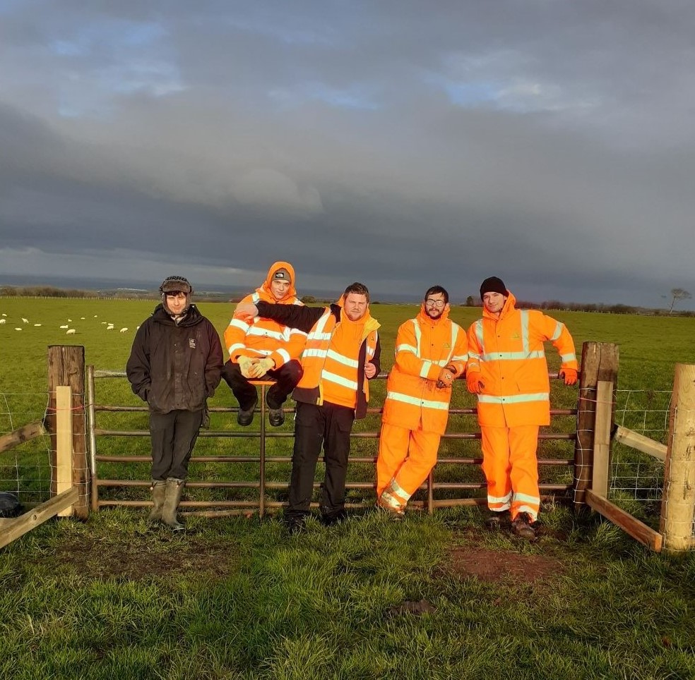 Photo of people in farm field wearing high-vis clothing