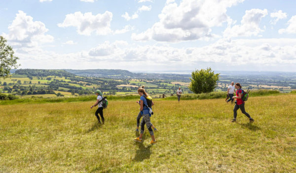 Photo of people walking on an elevated field. 